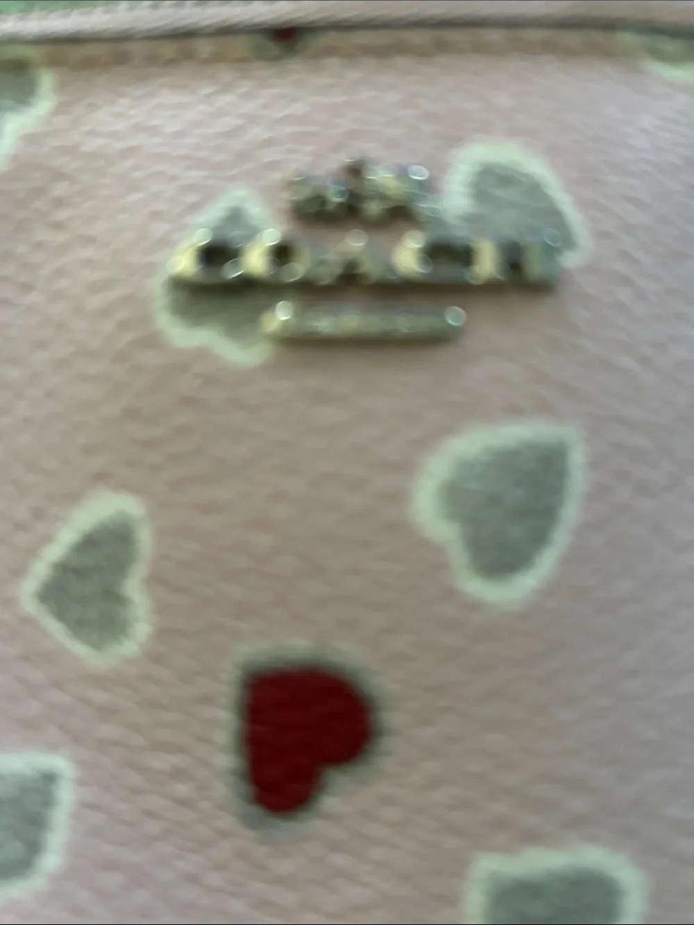 Coach Pink Leather Heart Wristlet with Red & Silver Hearts.  Two small marks